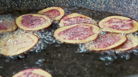 Deep frying native Peruvian potato slices. Video stock 341440032