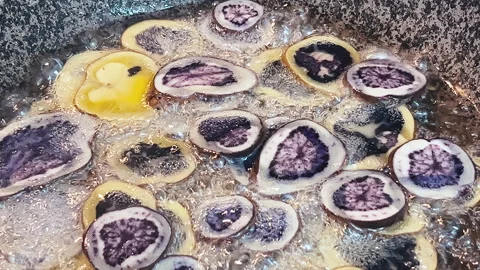 Deep frying native Peruvian potato slices. Stock Footage 341440807