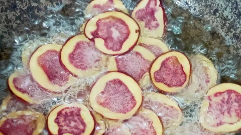 Deep frying native Peruvian potato slices. 動画素材 344986173