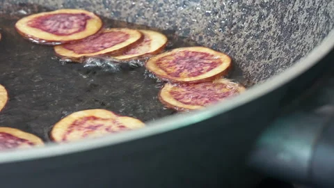 Deep frying native Peruvian purple potato slices. Stock Footage 339078290