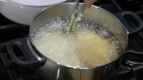 Deep frying pork chop in a pot, 4k, homemade food, kitchen Stockbeeldmateriaal 252168180