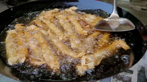 Deep frying pork meat wrapped in bean curd skin in hot wok Stock Footage 237909360