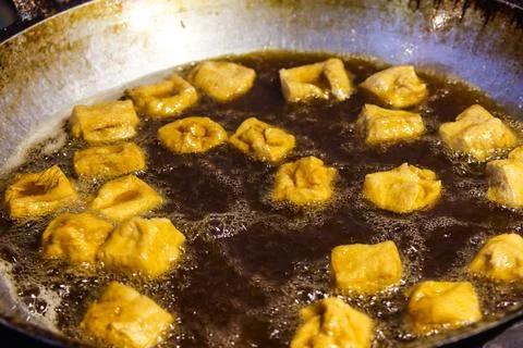 Deep Frying Process of Tahu Sumedang Cubes Bubbling in Hot Oil Cooking Wok Stock Photos