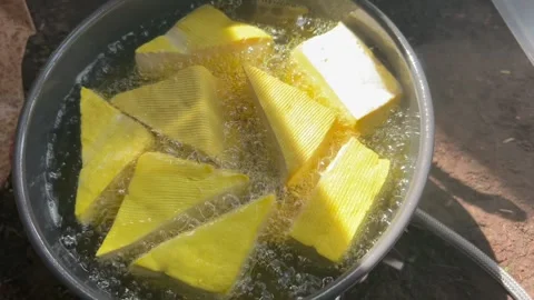 Deep Frying Yellow Tofu in Boiling Hot Oil Top View 库存影片 330440697