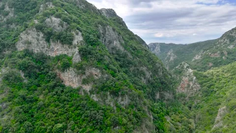 Deep Green Mountain Gorge and Distant Sea in Greece Stock Footage 336565388