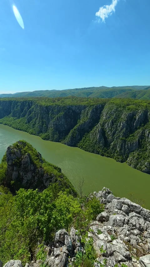 Deep green waters flow beneath towering. Balkan, Eastern Europe, POV Video stock 333634873