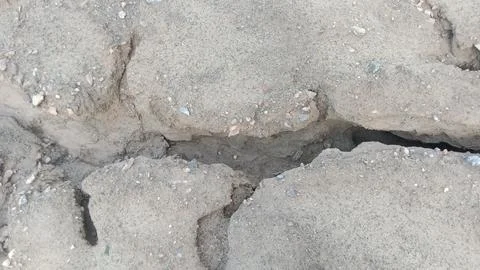 Deep Ground Crack and Soil Erosion Pattern on Dry Muddy Earth Stock Photos