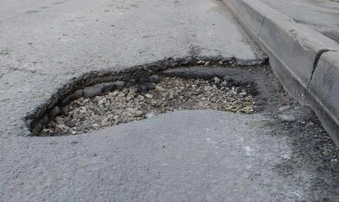Deep hole in the asphalt Stock Photos