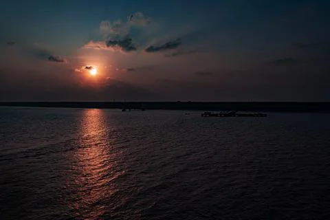 Deep Indigo Dramatic Sun Reflection over Ocean at Twilight Agatti Island Sunset Stock Photos