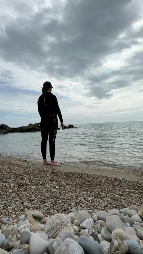 Deep leg stretch with hands up by the Adriatic Sea Stock Footage 303352347