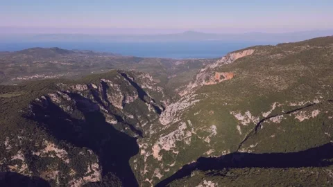 Deep Mountain Gorge and Limestone Cliffs Above the Sea in Greece Stock Footage 337870250