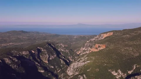 Deep Mountain Gorge and Limestone Cliffs Above the Sea in Greece Stock Footage 337870356