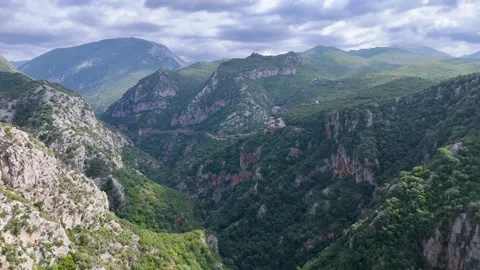 Deep Mountain Gorge with Winding Road in Greece Stock Footage 336562914