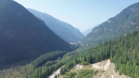 Deep Mountain Valley with Winding Highway Stock Footage 318817851