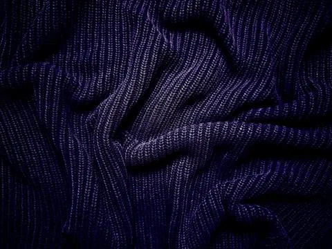 Deep navy ribbed knit wool fabric intricate textured folds macro Stock Photos