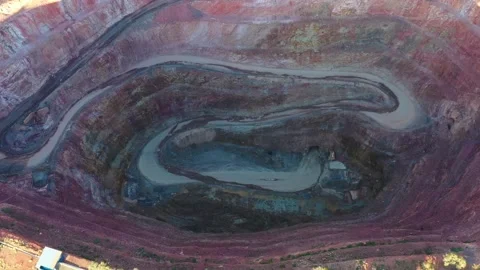 Deep open pit mine of copper ore in Cobar town of outback – aerial down 4k. Stock Footage 168384056