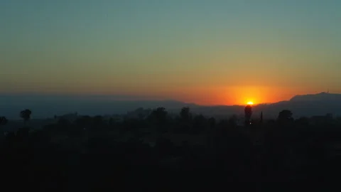 Deep orange sunset behind mountain range Stock Footage 340393971