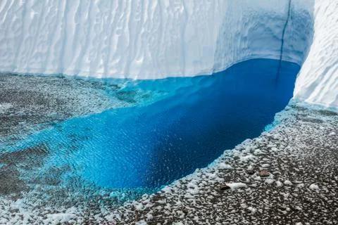 Deep oval shaped  blue pool on a glacier in Alaska. Stock Photos