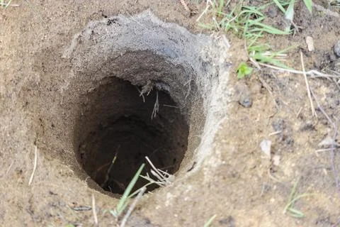 Deep pit in the ground. Digging a hole. Water Well Drilling, Stock Photos
