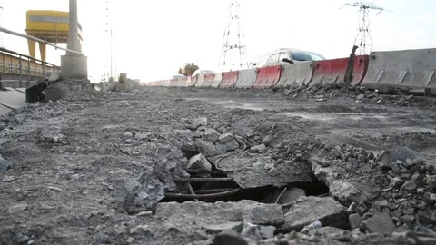 Deep pit on the road. Damaged asphalt. Road repair Stock Footage 152077581
