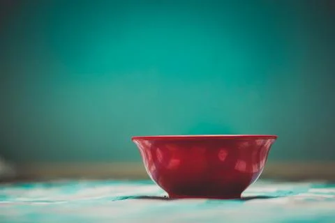 Deep plate in the interior of the kitchen table on a checkered tablecloth on Stock Photos