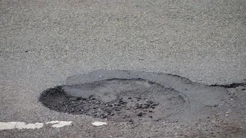 Deep pothole in wheel tracks Stock Footage 167237512