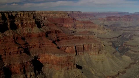 Deep red and orange layered cliffs fill the canyon Stock Footage 329761349