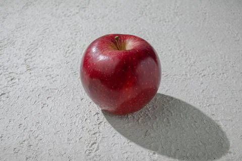 A deep red apple isolated on a clean white background, symbolizing health, .. Stock Photos