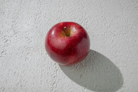 A deep red apple isolated on a clean white background, symbolizing health, .. Stock Photos