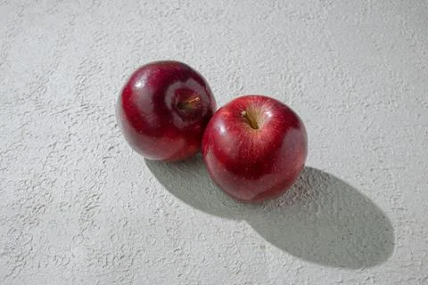 A deep red apple isolated on a clean white background, symbolizing health, .. Stock Photos