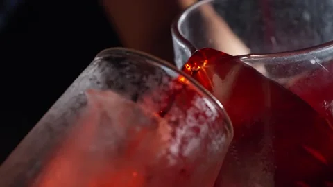 Deep Red Cocktail Poured into Chilled Glass Over Ice Stock Footage 337862623
