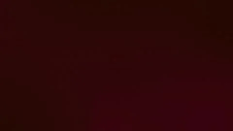 Deep red gradient with subtle texture, creating a seamless loop background. 4K. Stock Footage 309955728