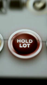 Deep red hold lot button fills vertical frame Stock Photos