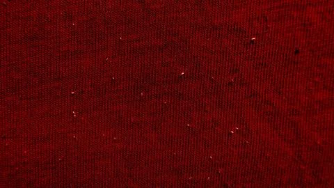Deep red knitted fabric texture with subtle glistening specks evoking cozy Stock Photos