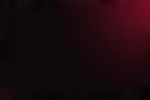 Deep red light leak on black background creates mysterious atmosphere for d.. Stock Photos