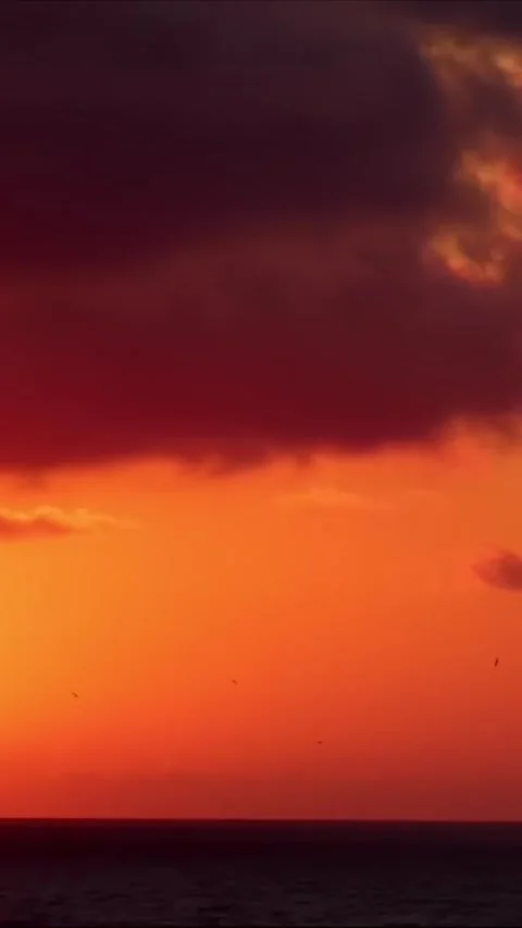 Deep Red Sunset Sky with Dark Clouds - Moody Evening Horizon Видео 334585058
