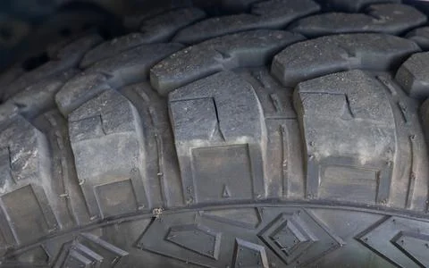 Deep off-road rubber tire tread on four-wheel drive vehicle in outdoor settin Stock Photos