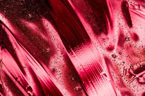 Deep ruby red metallic fluid ripple texture 写真素材