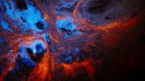 Deep Space Style Blue and Orange Ink Swirl With Star-Like Specks Stock Footage 346607413