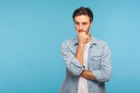Deep in thoughts. Portrait of smart handsome man in worker denim shirt standi Foto stock