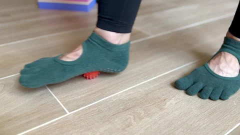 Deep tissue fascia foot rolling with spiky massage ball. Stock Footage 243272277