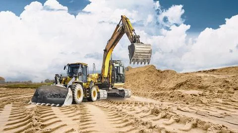 Deep tracks on the sandy surface show heavy machinery operating under cloudy  Photos