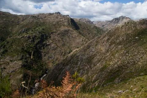 A deep valley between high mountains Stock Photos