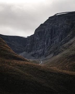 A deep valley with steep cliff. A river on the bottom of valley. Stock Photos