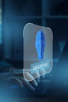 Deepfake technology displayed on a screen while a person types on a laptop in a Stock Photos