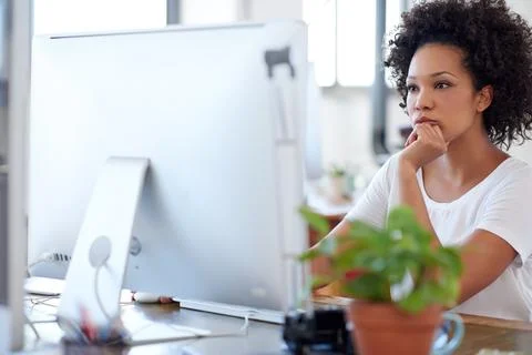 Deeply involved with solution seeking processes. Confident woman working at her Stock Photos