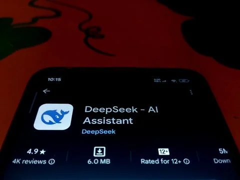 Deepseek Ai assistant App installing from Playstore on smartphone. Stock Photos