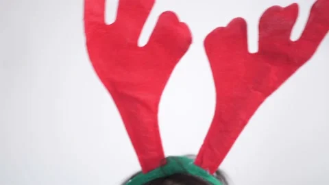 Deer antlers playfully move from side to side on a white background . Christmas Stock Footage 168403096