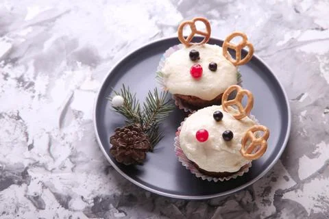 Deer shaped cupcake on gray background. Decor for Christmas Stock Photos