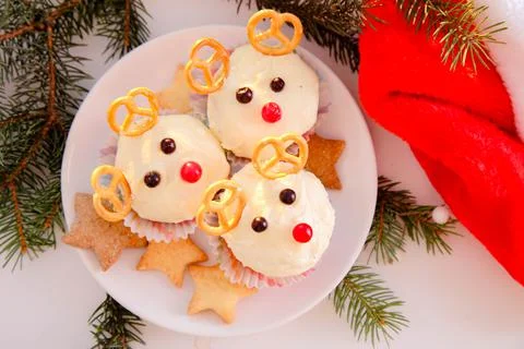 Deer shaped cupcake on a white background. Decor for Christmas Stock Photos